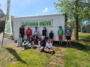 Students in front of a trailer ""clothing drive"