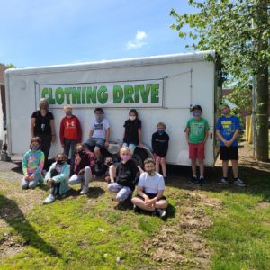 Students in front of a trailer ""clothing drive"