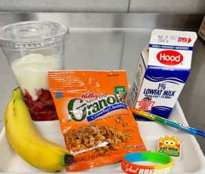 Tray with milk, granola, yogurt, banana, bracelet, pencil and earser